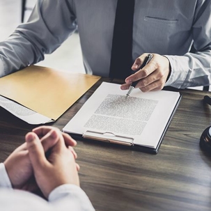 man with a clipboard and papers on his desk